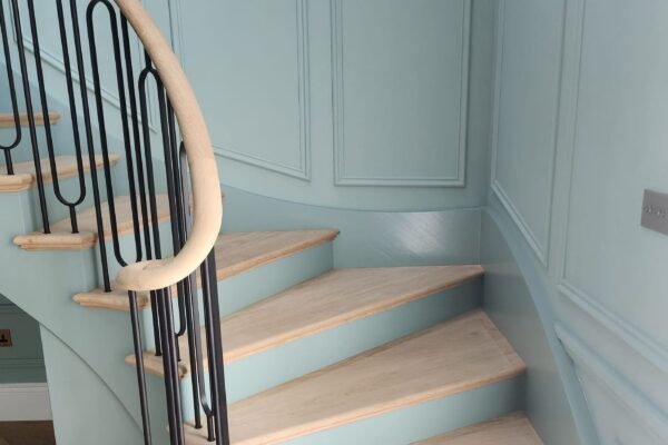 Curtail step and curved handrail detail on a bespoke oak staircase