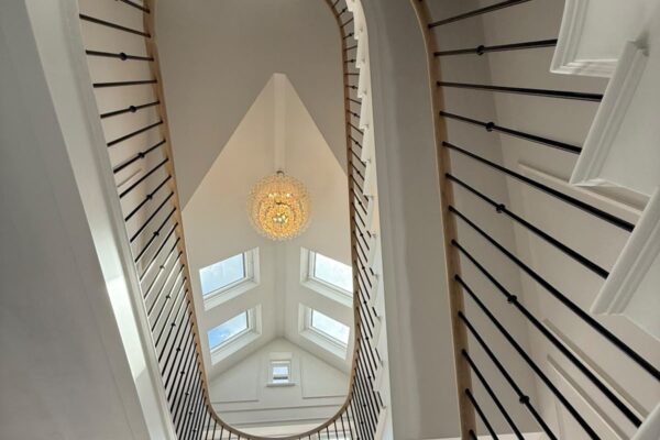 Curved staircase and galleried landing viewed from the hall below