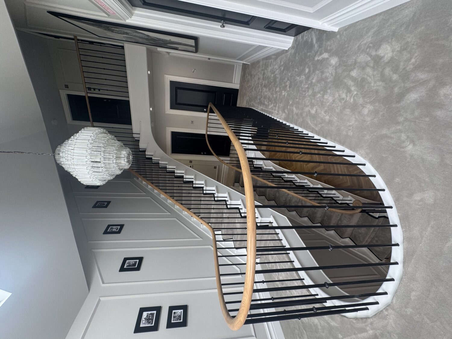 Galleried landing with a curved balustrade and continuous solid oak handrail above an open stairwell