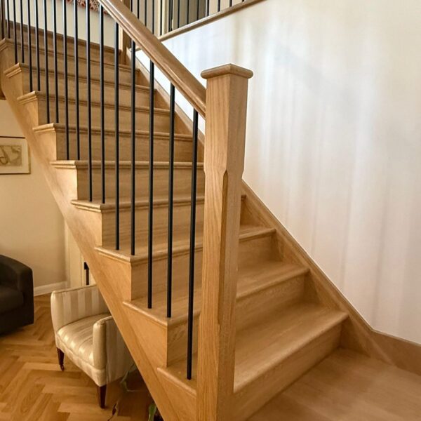 Solid oak staircase with iron spindles in an oak framed hall