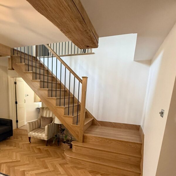 Solid oak staircase with iron spindles in an oak framed hall