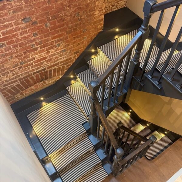 Painted staircase with stair runner in a period hallway